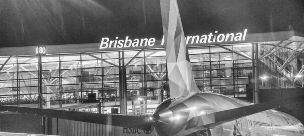 How can I travel between Brisbane Domestic and Brisbane International Airport terminals?